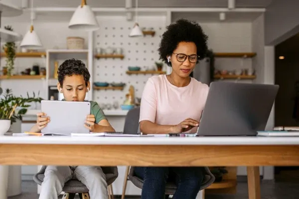 mother and son using laptop and tablet
